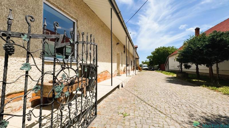 A family house on Milhostovská Street in Trebišov with a wrought iron gate and a landscaped entrance.