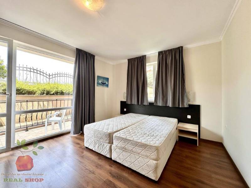 A recreational apartment with a double bed and a balcony, providing privacy and comfort.