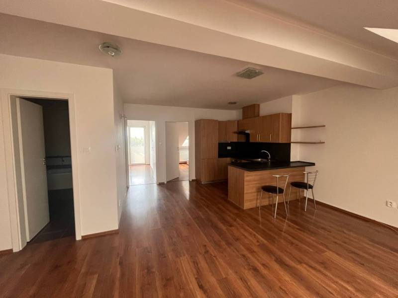 Kitchen with dining area, wooden floors, bright walls, 3-room apartment.