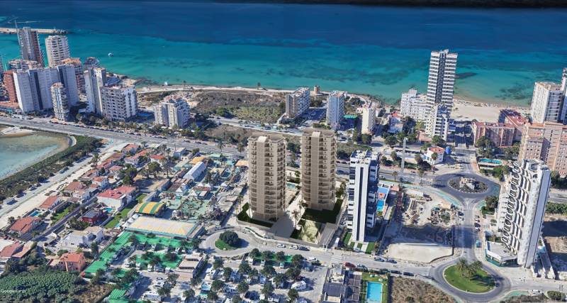 A view of the beach resort and residential buildings in the city of Calp with a sea view.