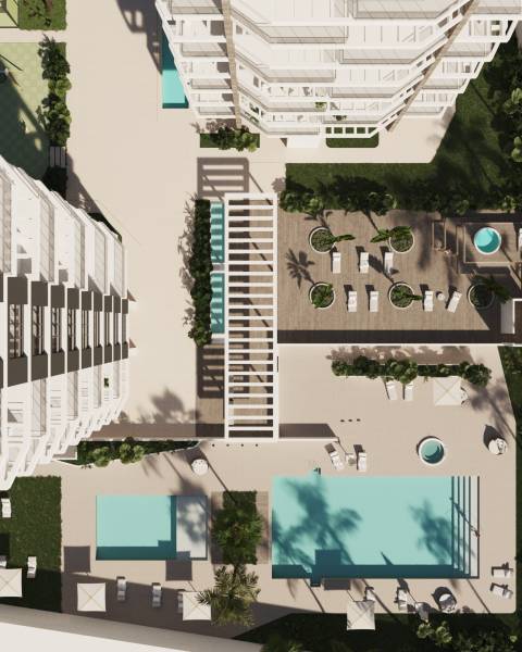 A view from above of the terrace with pools and loungers at a 3-bedroom apartment in Calpe.