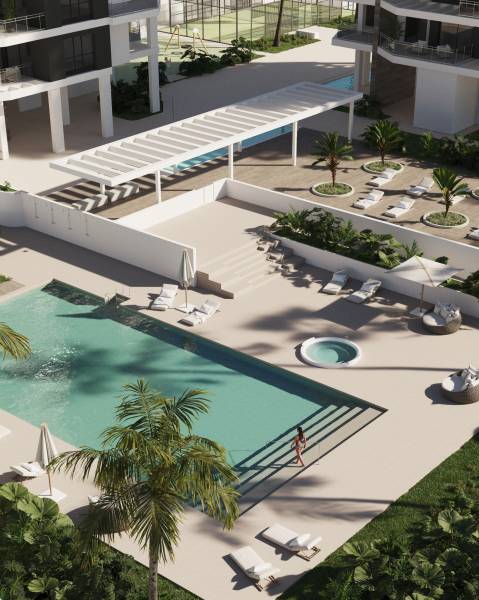 Exterior of a 3-bedroom apartment in Calpe with a pool and loungers in a residential area.
