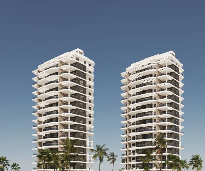Modern residential towers in Calpe with palm trees and a blue sky, ideal for a 3-bedroom apartment.