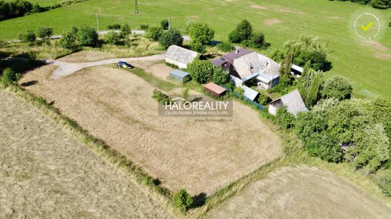 A family house in Ploské surrounded by nature, fields, and greenery.