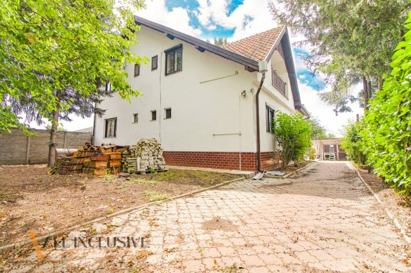 A family house in Žihárec with a landscaped garden and a paved driveway.