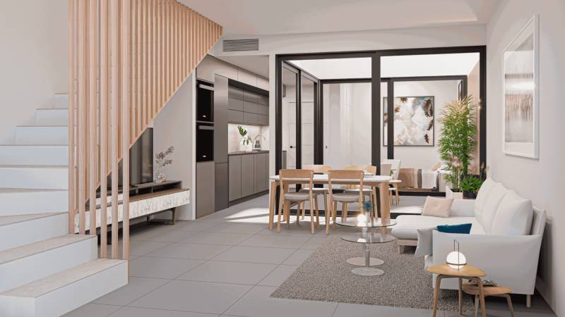 Interior of a family house with a kitchen, dining area, staircase, and comfortable seating.