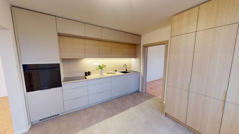 A kitchen in a 3-room apartment with wooden cabinets and appliances.