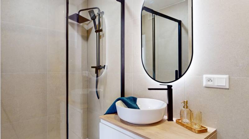 Bathroom with a shower and a mirror in a 3-room apartment, elegant details and design.