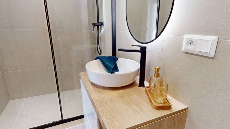Bathroom with a shower and a sink in a 3-room apartment.