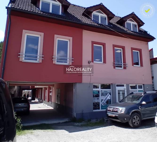 Commercial premises in Brezno with multiple windows, parked cars in front of the building.