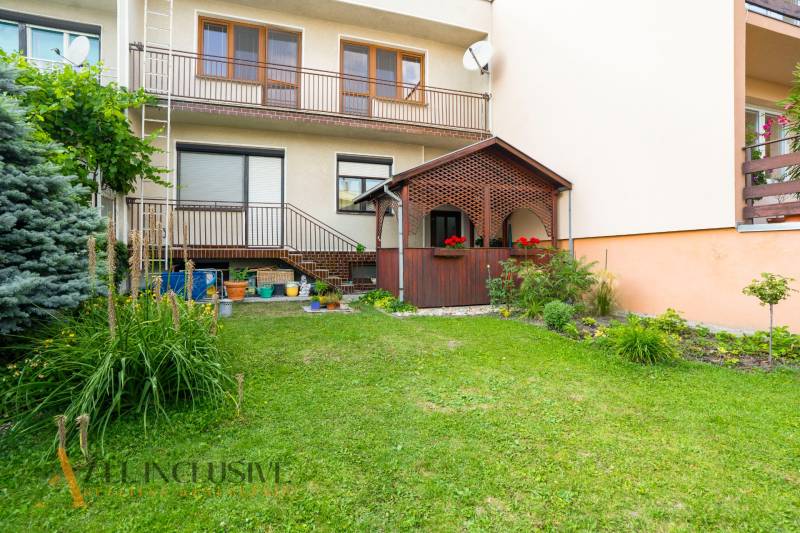 A family house in Dunajská Streda with a garden and a gazebo, surrounded by greenery and flowers.