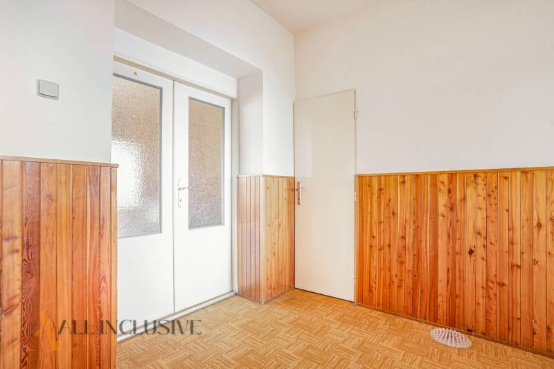 Wooden cladding and light doors in the interior of a family house.
