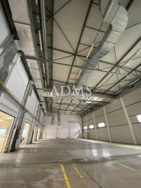 Interior of warehouses and halls with high ceilings, air conditioning, and empty floors.