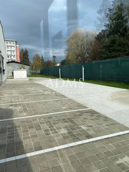 An empty parking space near warehouses and halls on Bytčická Street in Žilina.