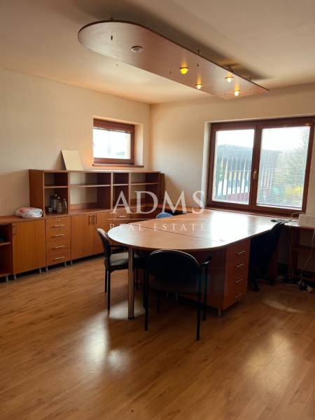 Office room with wooden furniture, windows, and ceiling lighting. Warehouses and halls.