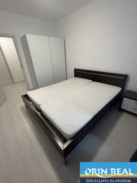 Bedroom with a double bed and a wardrobe in a 2-room apartment.