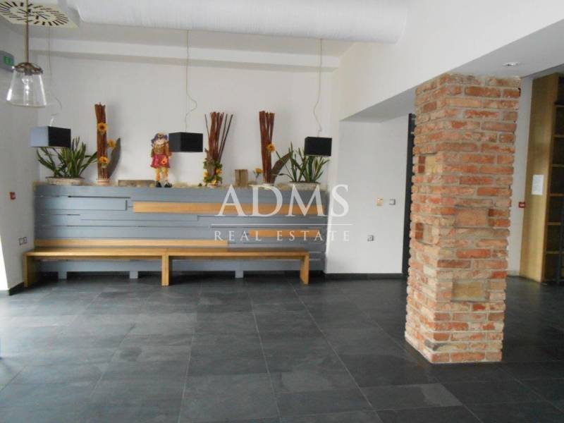 Gastro premises with a bench, decorations, and a brick wall in the interior.