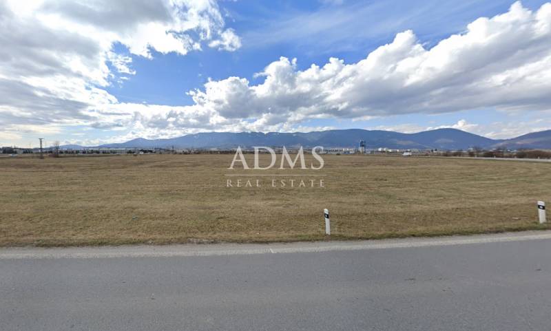 Commercial land in Sučany, flat terrain, visible mountains in the distance, suitable for construction.