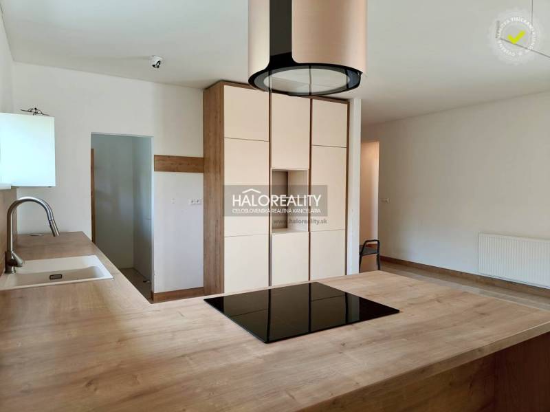 A kitchen unit with wooden countertops and light cabinets in a family house.