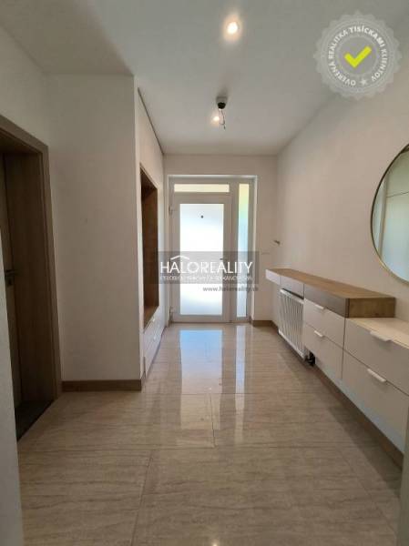 A hallway with a mirror and storage space in a family house.