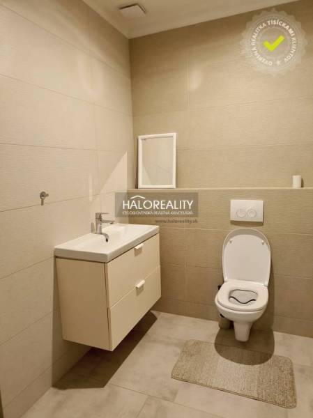 Bathroom with a sink and toilet in a family house.