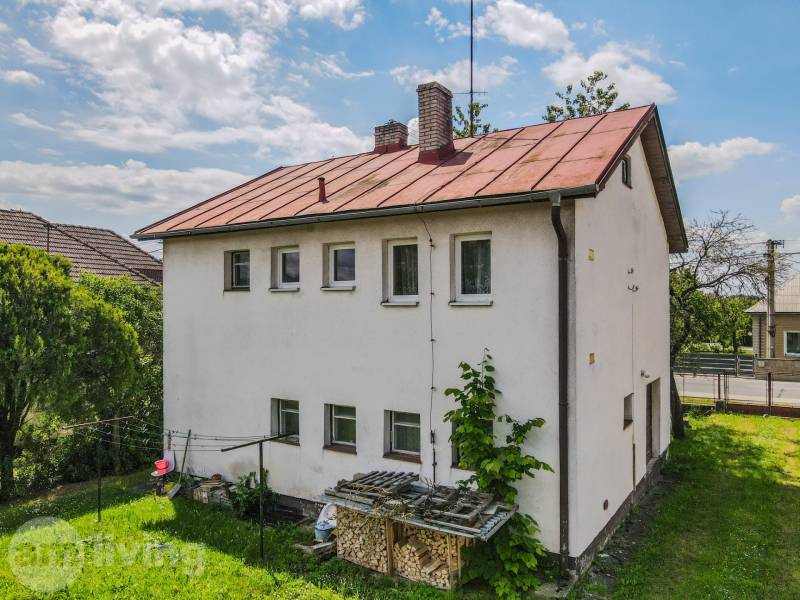 A family house in Pruské with a grassy garden and a simple architectural style.