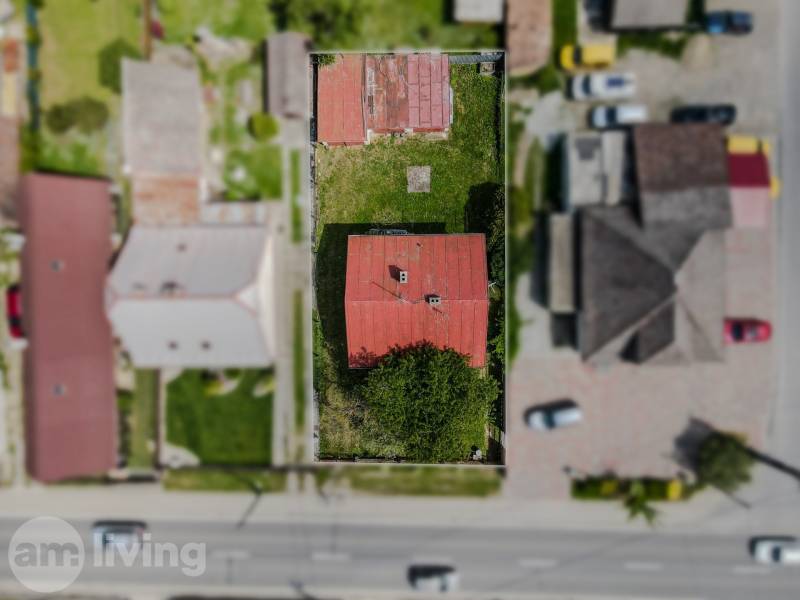Aerial view of a family house in Pruské with a red roof and a garden.