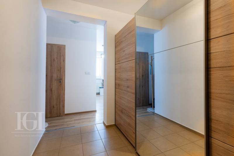 Interior of a 2-room apartment with tiles and wooden elements in the hallways.