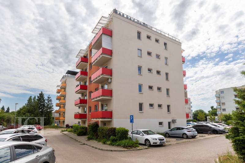 Apartment building on Potravinárska Street in Nitra with an adjacent parking lot.