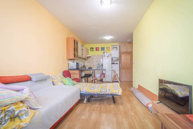 Bright room with a chair, bed, and window in a 3-room apartment.