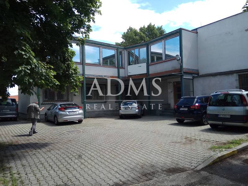 A courtyard with parked cars at the manufacturing premises on Beckovská Street in Bratislava - Ružinov.