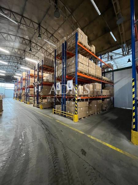 Warehouses and halls with shelves full of boxes and section labels K, L.