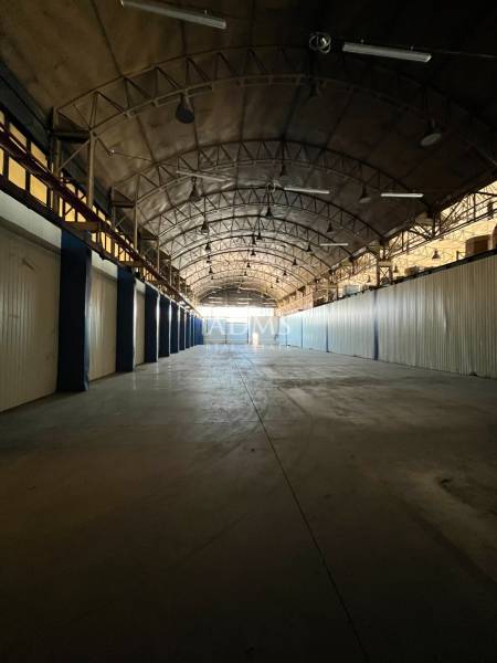 Spacious interior with an arched roof, suitable for warehouses and halls.