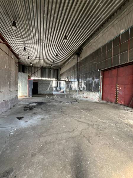 Interiors of warehouses and halls with iron roofs and concrete floors.