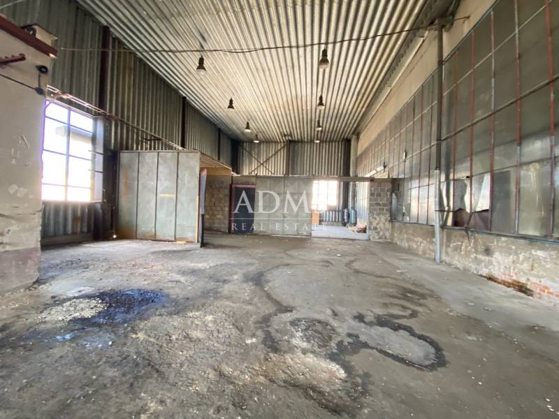 Industrial interior of warehouses and halls with high ceilings and metal panels.