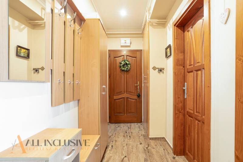 Wooden interior and coat rack wall in the hallway of a 2-room apartment.