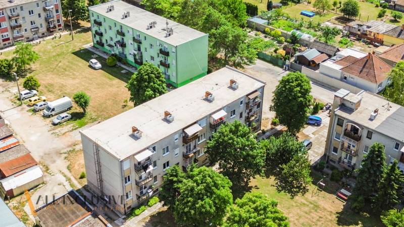 Aerial view of apartment buildings and greenery in Gabčíkovo, suitable for a 2-room apartment.