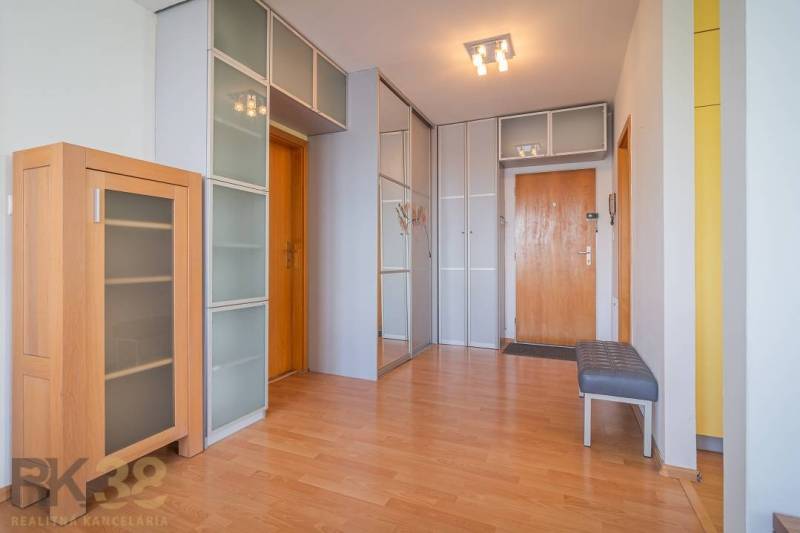 Entrance hall in a 3-room apartment with wooden furniture and a built-in wardrobe.