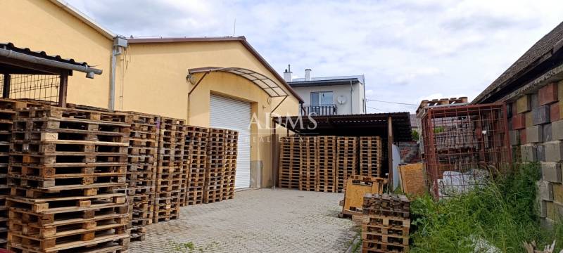Warehouses and halls in Ilava on Kpt. Nálepku Street with pallets stored in the yard.