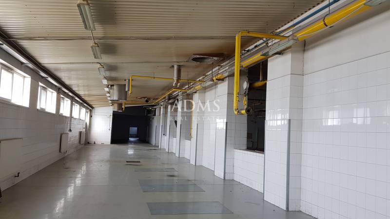 Interior of an industrial space with yellow pipes and white walls in warehouses and halls.