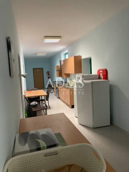 Offices with a kitchenette, tables, and chairs, suitable for breaks and refreshments.