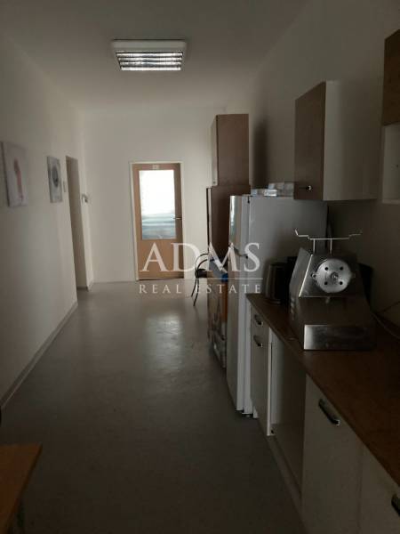 A small kitchenette in offices, with a refrigerator and a meal preparation appliance.