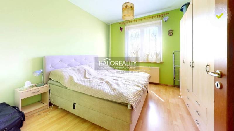 A bright bedroom with a bed, wardrobes, and wooden flooring in a 3-room apartment.