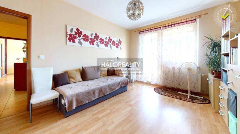 Living room with a sofa, armchair, and decorations in a 3-room apartment.