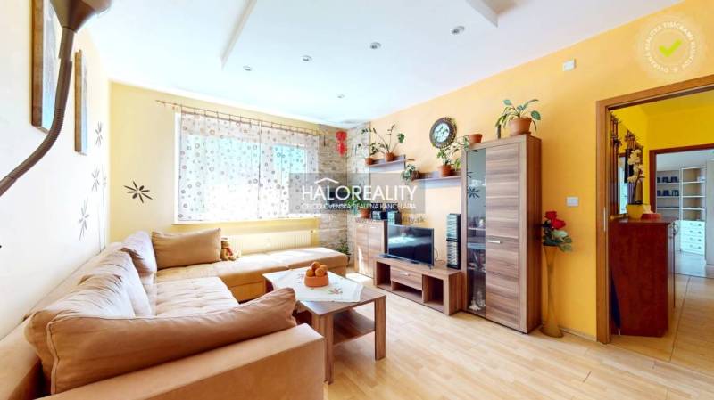 Living room in a 3-room apartment with light furniture, a sofa, and decorations.