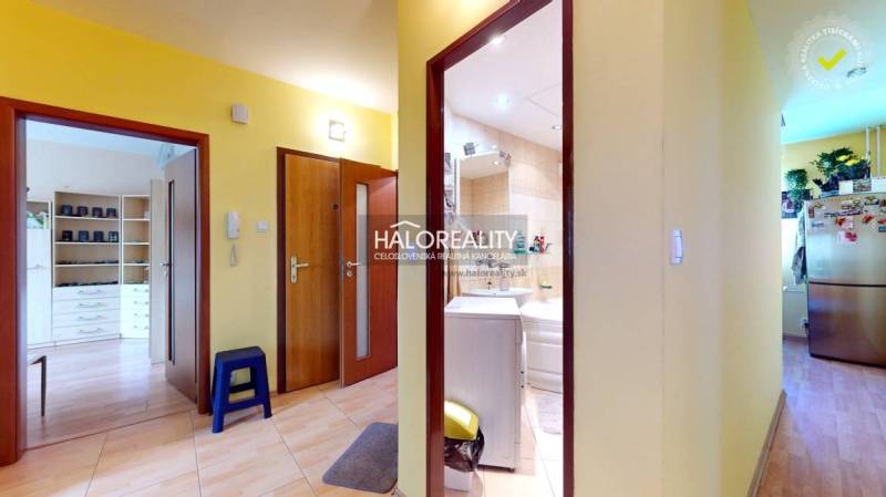 A hallway in a 3-room apartment with doors to the bathroom, kitchen, and living room.