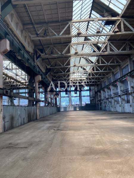Industrial warehouses and halls with steel structures and glass roofs.