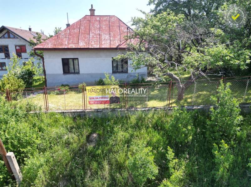 A family house in Vrbov, surrounded by trees and a fence, offered for sale.