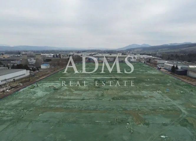 Commercial land area in Dubnica nad Váhom with adjacent industrial buildings.