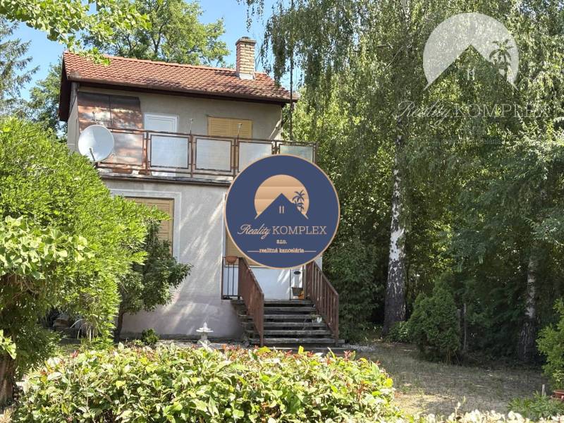 A cottage in Radvaň nad Dunajom, surrounded by greenery with a terrace and satellite.